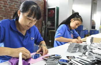 People work at factory in relocation area of south China's Guangxi